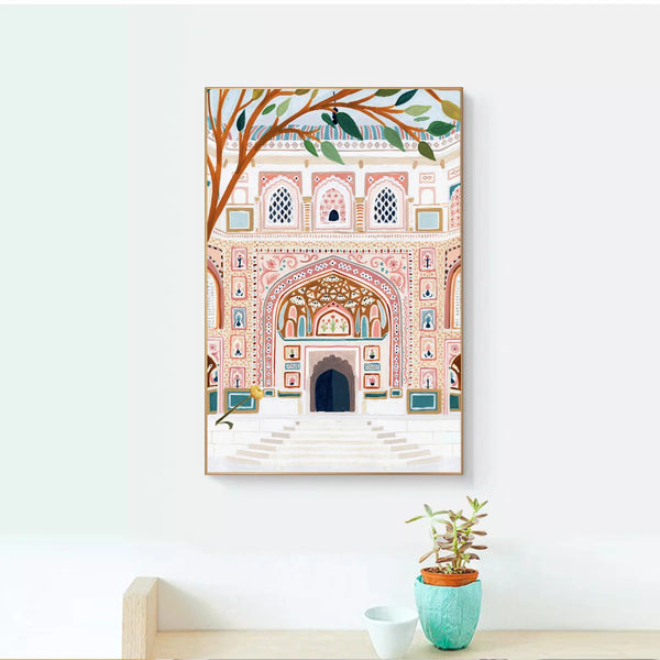 Dans une pièce aux murs blancs avec une étagère en bois avec une petite plante a une toile affichée aux murs. La toile est une style peinture de monument arabe dans un style scandinave aux couleurs pastels.