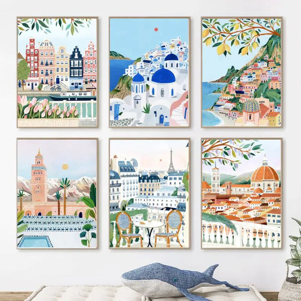 Six toiles de style peinture minimalistes sont affichées au mur. Les tableaux sont des peintures de villes. Il y a Paris, Amsterdam, Santorin, Positano, Rome, Marrakech.