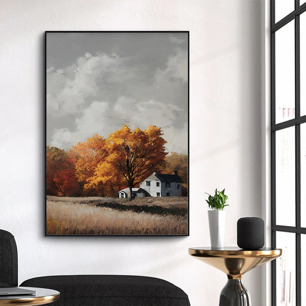 Dans un salon au style moderne une toile style peinture à l'huile représentant un paysage de forêt avec maison de campagne en automne est affichée.
